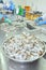 Workers are rearranging peeled shrimp onto a tray to put into the frozen machine in a seafood factory in the mekong delta of