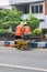 Workers repairing traffic lane dividers and separators made of concrete on asphalt roads