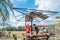 The workers is roofing a metal gazebo frame  with red  zinc in sunny day