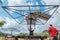 The workers is roofing a metal gazebo frame  with red  zinc in sunny day