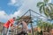 The workers is roofing a metal gazebo frame  with red  zinc in sunny day