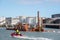 Workers sailing to a dredger barge