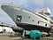 Workers sandblast, sand an expensive luxury yacht for painting and preparing it for launch, maintenance of expensive yachts,