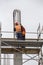 Workers on scaffold platform tied rebar and steel bars