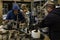 Workers service a machine for applying stickers on bottles in a workshop on the territory of the Cremisan winery, located in Beit