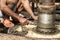 Workers at a shipyard in Dhaka Bangladesh, with their oil-smeared hands, attach a chain around the drive axle of a ship