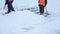 Workers with shovels to clear the snow from the stairs in the town square.