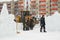 Workers shovels to remove the snow on the ice town