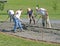 Workers smoothing concrete