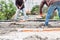 Workers spreading concrete over the slab