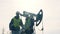 Workers standing on an oil derrick background, close up.