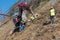 Workers strengthen the mountainside with a metal mesh that prevents rockfall on the road. Specialized equipment is used.