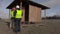 Workers talking near wooden building