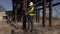 Workers talking and walking near metal tanks