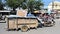 Workers transport goods by motorbike and cart