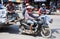 Workers transport goods by motorbike and cart