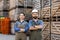 Workers in uniforms work in warehouse for sale and distribution of organic fruits