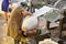 Workers using industrial machinery in the production of traditional hats at the Sombreros Sucre factory in Sucre, Bolivia