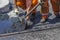 Workers using a shovel to spread mastic asphalt