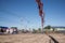 Workers using a wooden spatula for cement after Pouring ready-mixed concrete by placing boom and concrete pump