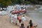 Workers and volunteers line up To put the plastic pallet in the sea near the beach In order to block crude oil.