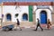 Workers walk along a street at the port of Essaouira, Morocco.