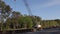 Workers walking at a road bridge construction site and traffic passing