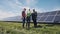 Workers walking in beside row of solar panels