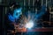 A Workers are welding steel at a heavy industry factory. Industrial safety first concept