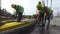 Workers work at a construction site. The builder works with a chainsaw.