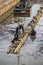 Workers working in the polluted river on concrete revetment