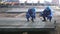 Workers writing id numbers on steel blocks