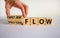 Workflow or process flow symbol. Male hand flips wooden cubes and changes words `process flow` to `workflow`. Beautiful white