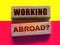 Working abroad words on wooden blocks. Business human resources HR headhunting concept