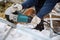 Working angle grinder in the hands of a worker. Gloves, sparks of metal.