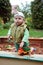 Working boy playing in a sandbox