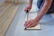 Working carpenter lays laminate flooring in the apartment. The concept of working professions