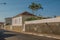 Working-class old house with wall in an empty street on a sunny day at SÃ£o Manuel.