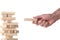 Working  concept:  man`s hand positioning a wood block in a tower made with wooden blocks with clipping path and copy space for y