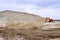 Working digger in a quarry produces sand