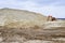 Working digger in a quarry produces sand