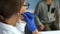 Working doctor`s office pediatrician. A female doctor puts on a phonendoscope and prepares to listen to the patients