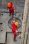 A working driller installs a drill pipe raised from a well.