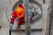 A working driller installs a drill pipe raised from a well.