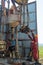 A working driller lifts drill pipes from a well.