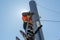 Working electrician tied to the pole with a safety rope