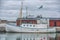 A working fishing boat in the harbour with dramatic cloudy sky