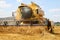 Working harvesting combine in the field of wheat