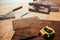 Working instruments lying on OSB background. Power jigsaw, scroll saw, try square, measuring tape and putty knife applicator on