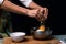 Working in the kitchen. Cracking an egg in a bowl. Cooking apple pie. Cook table. Dark black background